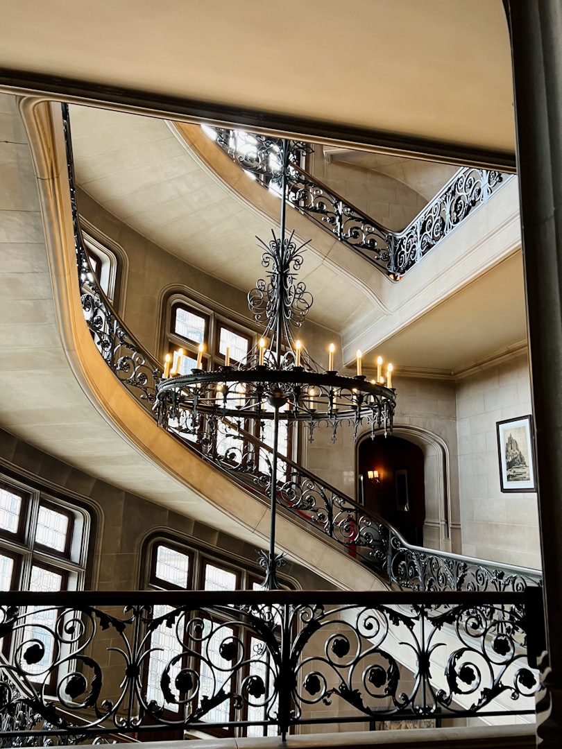 Interior of an Italian palazzo stairway with dramatic overhead lighting, inspiration for Summer At The Palazzo by Susie Sharp